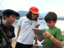 Young students exploring nature with an iPad