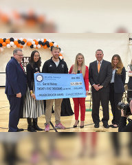 The Milken Educator Awardee from Wyoming receives a check.