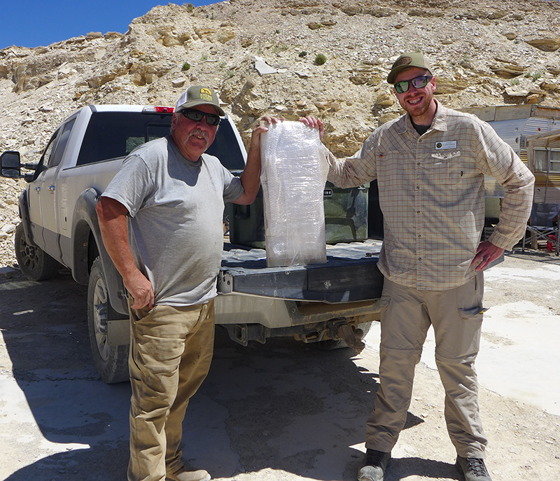 Rick Hebdon of Warfield Quarries poses with WSGS scientist Colby Schwaderer and the Paleoamphiuma tetradactylum Fossil