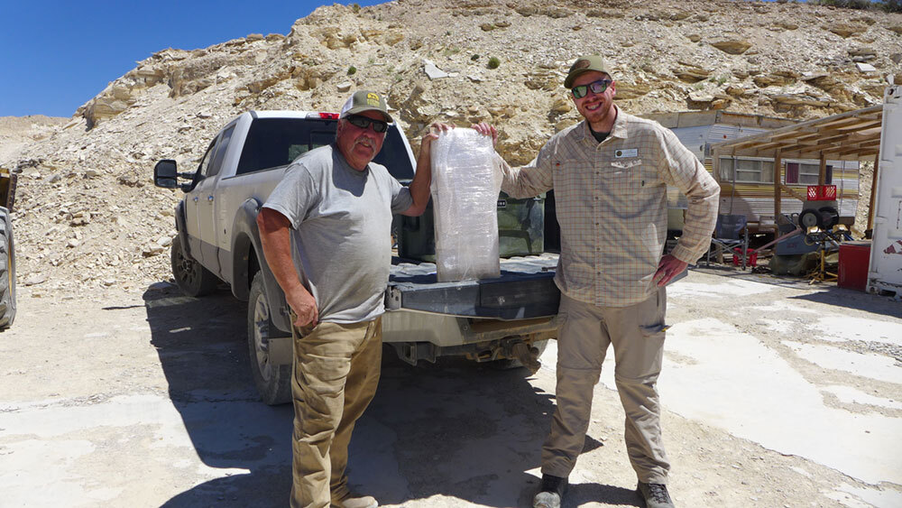 WSGS geologist Colby Schwaderer meets with Rick Hebdon (Quarry Operator) to transfer a rare salamander fossil.