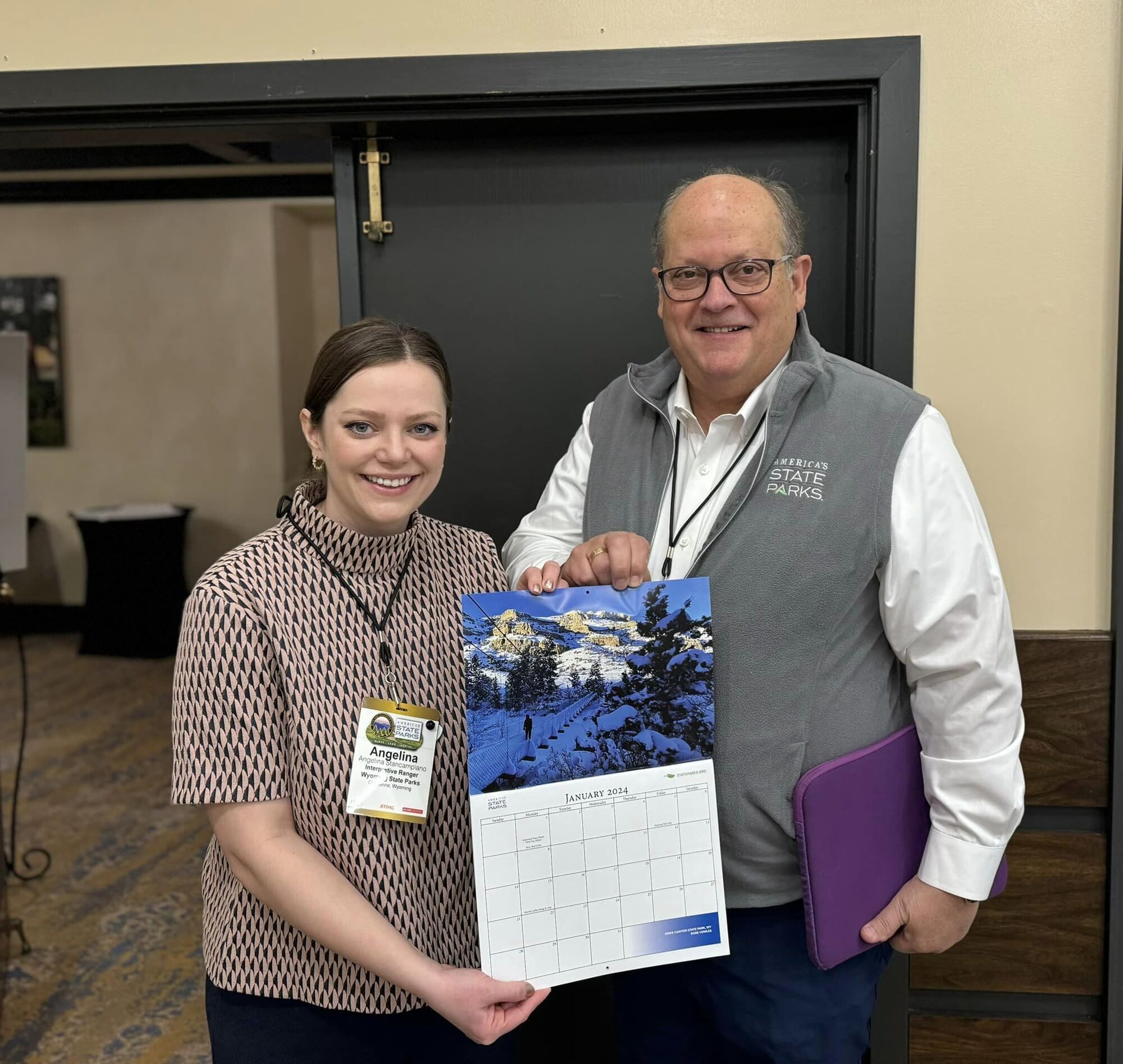 Ranger Angelina and Lewis Ledford holding NASPD's calendar