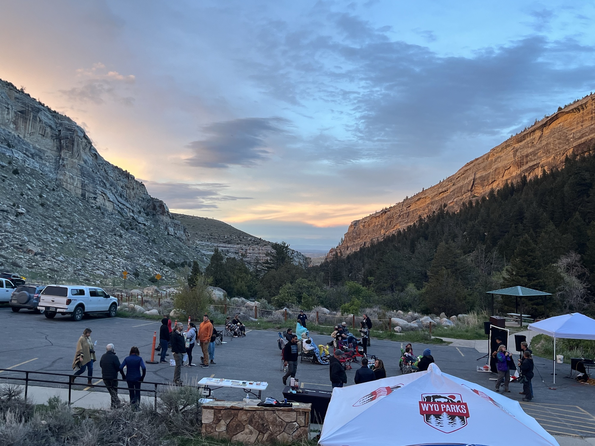 sunset over sinks canyon overlooking parking lot with 40 people mingling