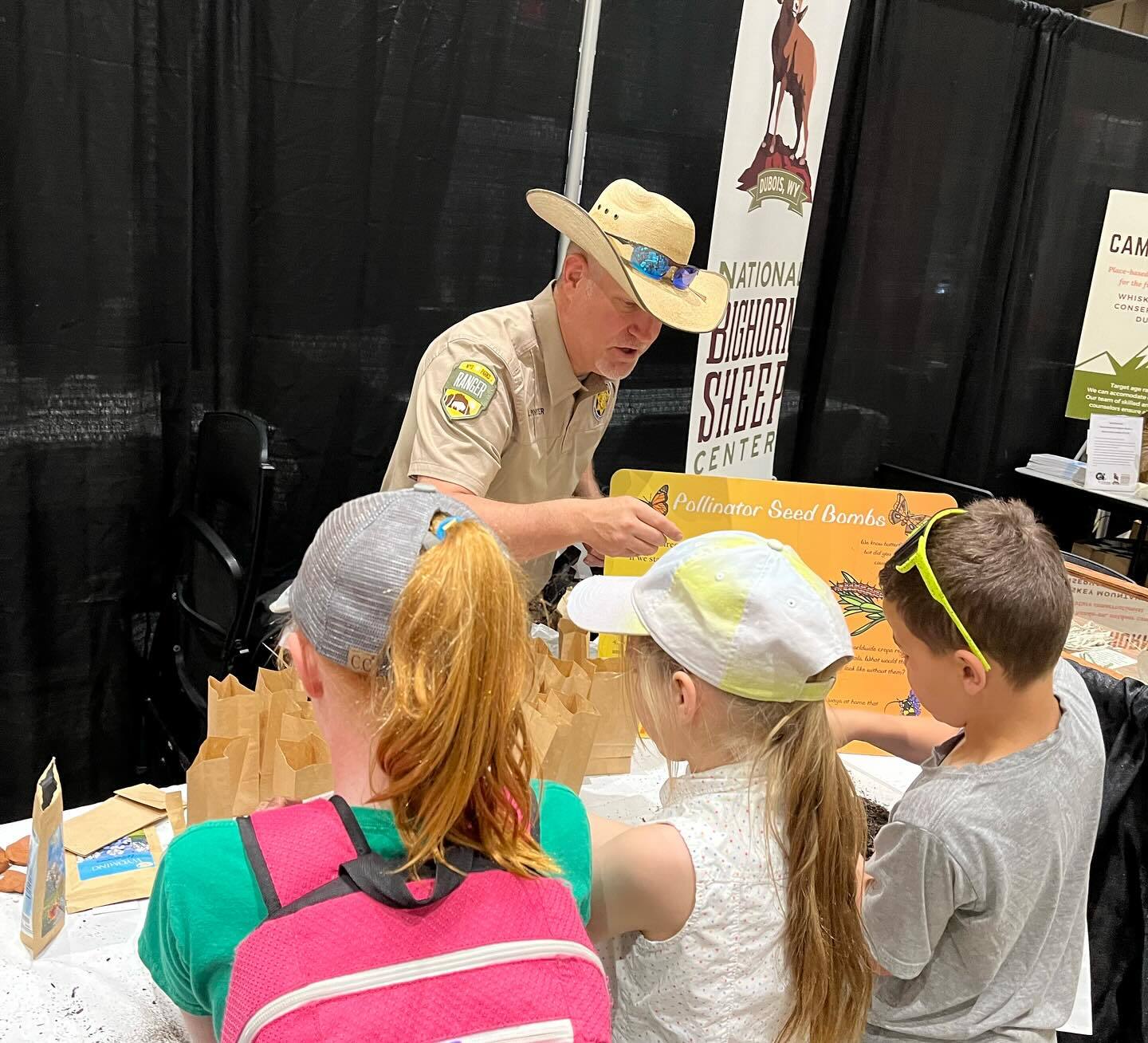 Ranger doing activity with kids on a field trip.