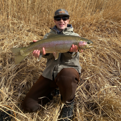 15 year old ultimate angler poses with trout