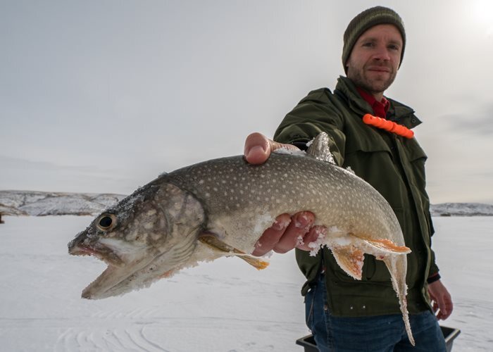 Ice angler holding a fish