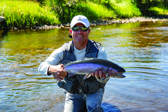 UW Coach Jeff Linder holding a trout