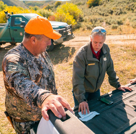 Kim Olson helping a hunter