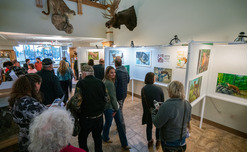 Guests view art show entries at the Game and Fish office in Cheyenne