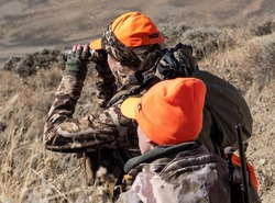 Hunters look for animals in the field