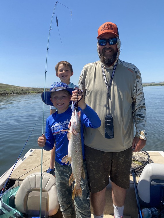 Kids showing off their caught fish