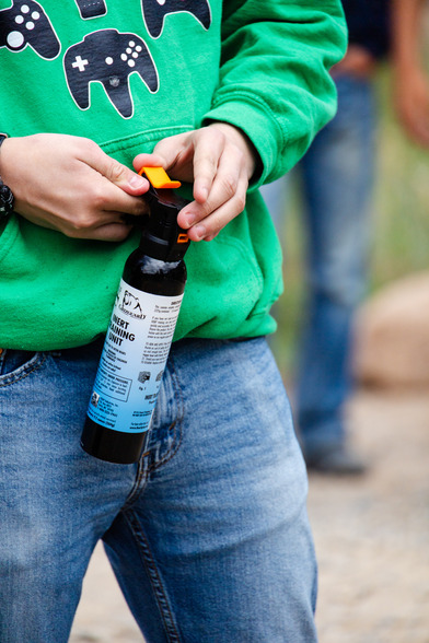 Young man holding bear spray 