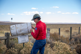 Game and Fish checking a sage grouse wing barrel 