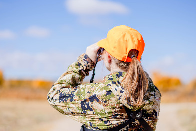 Woman hunting, wearing orange