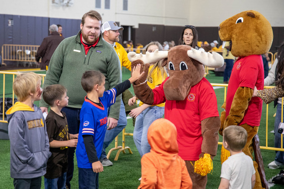 Mardy and the beaver with kids at the UW game