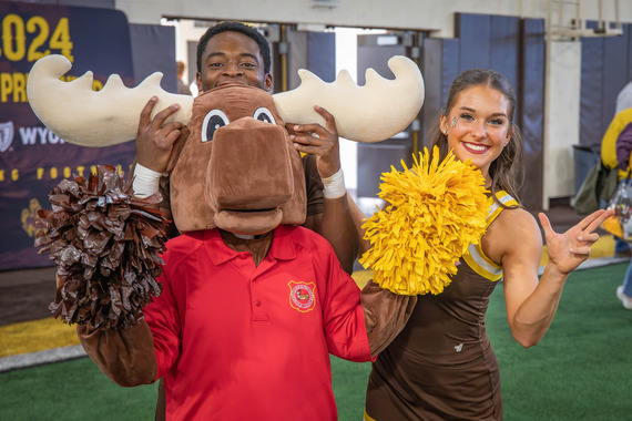 Mardy celebrates with cheerleaders