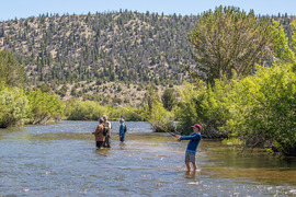 Anglers fly fish in the river at Whiskey Mountain Conservation Camp